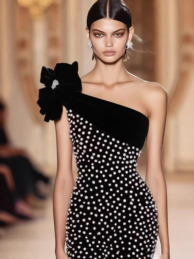 One shoulder black polka dot midi dress with bow detail for modern party looks