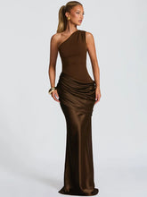 One shoulder satin maxi dress shown from the front, highlighting the diagonal neckline and smooth, elongated silhouette on a studio background.