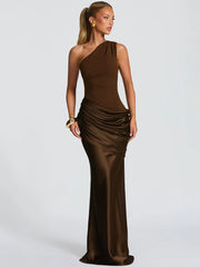 One shoulder satin maxi dress shown from the front, highlighting the diagonal neckline and smooth, elongated silhouette on a studio background.
