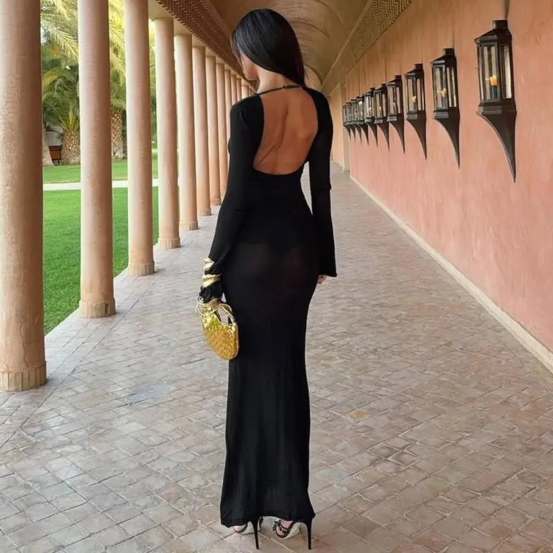Open back black maxi dress styled for modern event looks