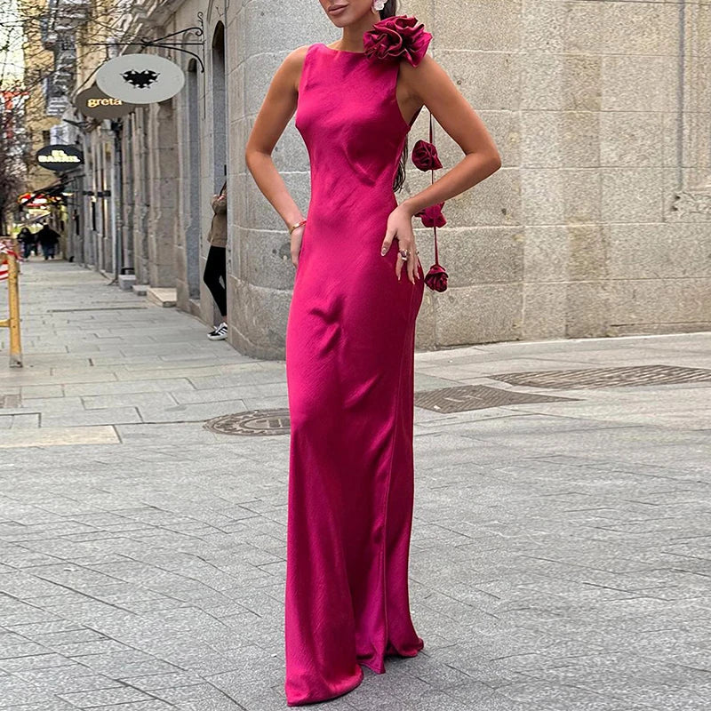 Open-back pink satin gown with floral detail