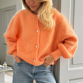 Orange knit cardigan styled for autumn layering and office days