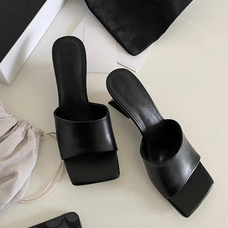 Black summer slides styled for street and outdoor wear