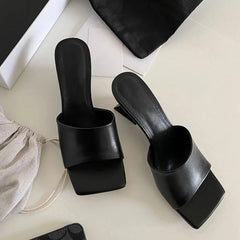 Black summer slides styled for street and outdoor wear