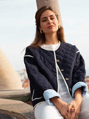 A woman wearing a printed cotton-padded jacket with a single-breasted front.