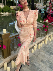 Peach floral midi dress with puff sleeves and lace-up waist, front view
