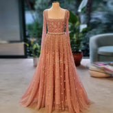 Peach-pink A-line evening gown with square neckline on mannequin
