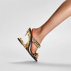 Front angle of peep-toe mules with chain accent across the foot, focusing on the open toe shape and statement hardware.