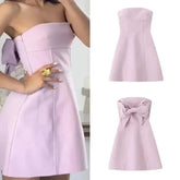 Pink bow strapless mini dress styled for chic summer parties