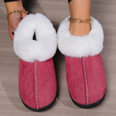 Pink faux suede slippers with white fluffy fur trim