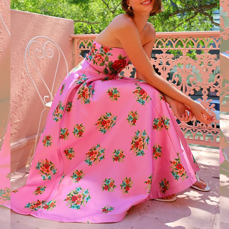 Woman in pink floral strapless maxi dress with pleated skirt