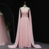 Floor-length formal dress with pleated skirt and flowing sheer cape detail