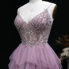 Full-length A-line gown with soft ruffle layers against draped backdrop