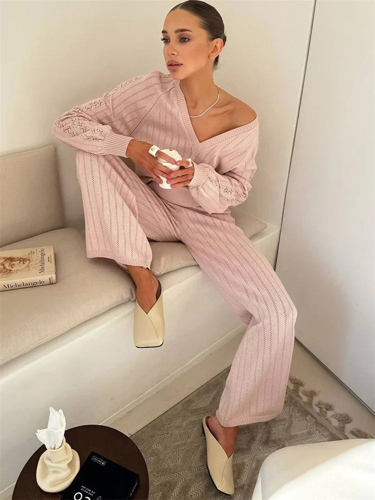 Woman wearing pink knit lounge set with V-neck top and high waist pants