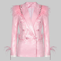 Front view of a pink sequin blazer with feathered shoulders, shown in a clean studio setting highlighting its tailored shape.