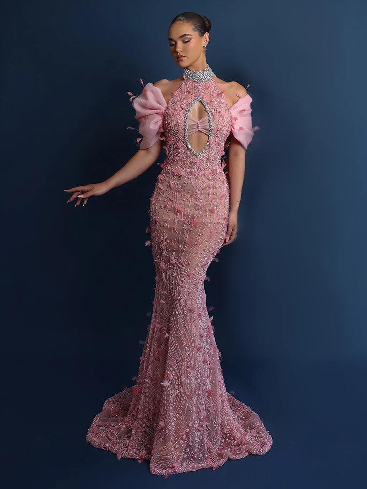 Pink sequin mermaid gown styled in a high-neck halter for gala elegance