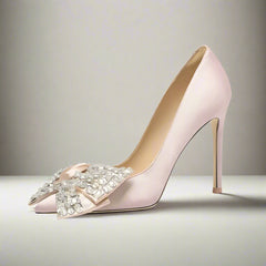 Pink silk pointed stiletto pump with rhinestone butterfly bow for spring banquet on a light gray background
