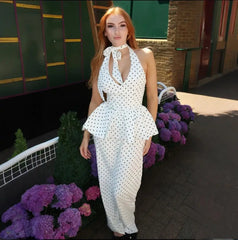 Woman wearing a plunge halter top and wide-leg pants outdoors