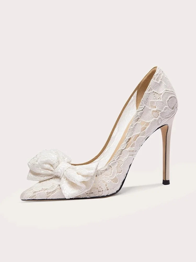 Pointed stiletto bridal pumps in white lace with oversized bows
