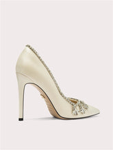 Top view of pointed-toe embellished pumps with crystal accents
