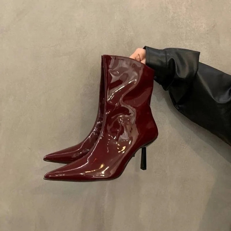 Shiny pointed-toe nonslip high heel boots for women are shown with a glossy finish on a neutral background.
