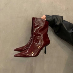 Shiny pointed-toe nonslip high heel boots for women are shown with a glossy finish on a neutral background.