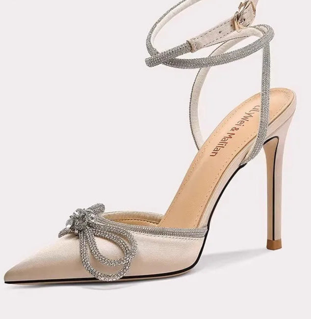 High-heeled shoe with decorative bow on a white background