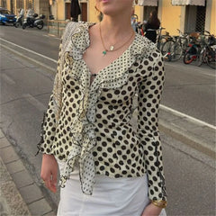 Woman wearing polka dot frill long sleeve slim fit blouse