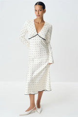 A close-up of the polka dot print on the maxi dress.