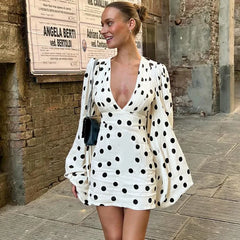 White polka dot mini dress with dramatic puff sleeves for retro style