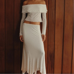 Woman wearing polka dot off-shoulder crop top and skirt set