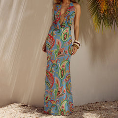 A woman wearing a printed halter V-neck maxi dress.