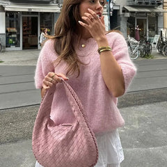 A woman modeling a printed knit short-sleeve top.