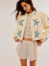 A woman wearing a printed cotton-padded jacket with a single-breasted front.