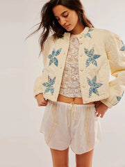 A woman wearing a printed cotton-padded jacket with a single-breasted front.