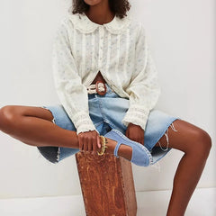 Close-up of the blouse collar showing the rounded Peter Pan shape and delicate printed pattern.