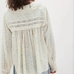 Detail view of the blouse sleeve and cuff highlighting the lightweight fabric and subtle print.