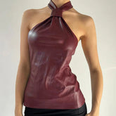 A woman modeling a PU leather halter top with a backless lace-up detail.