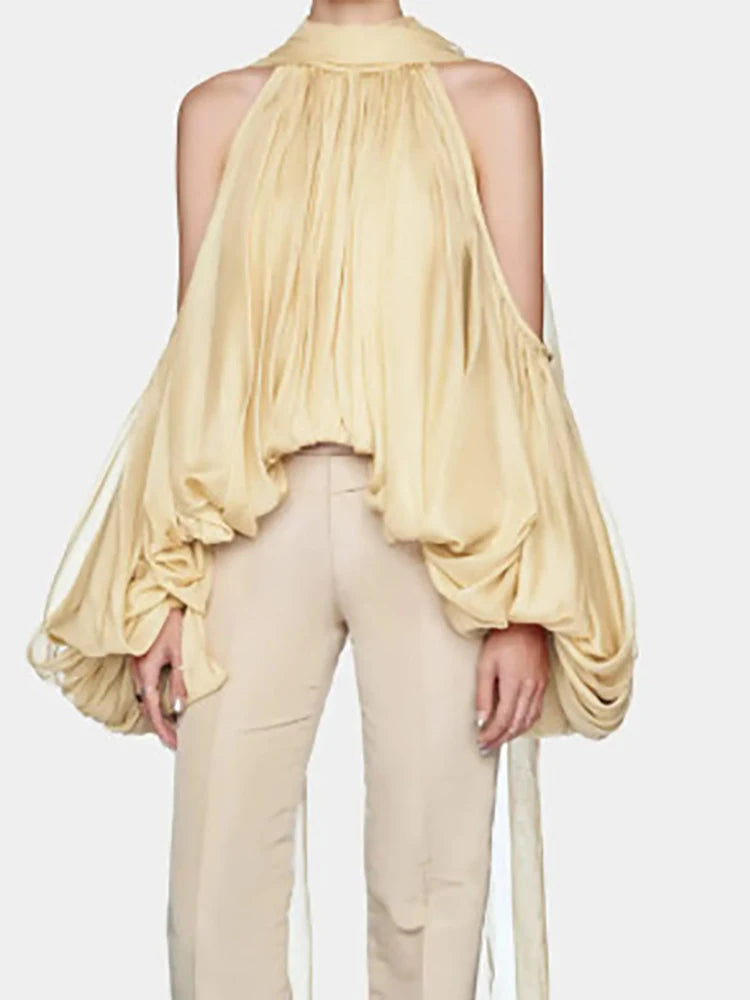 A close-up of the puff sleeve detail on the top.