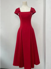 Close-up of the square neckline and puff sleeve detail on a midi dress