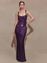 Woman wearing a purple rhinestone mesh long gown with a slim sheath fit
