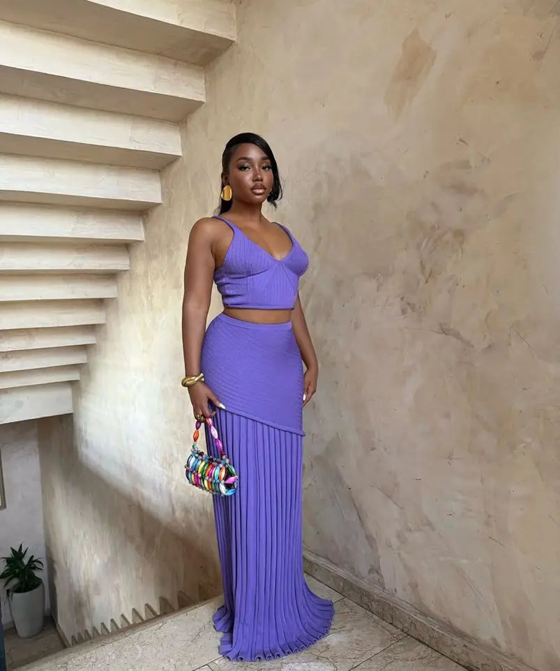 Purple two-piece set with crop top and pleated maxi skirt styled in stairwell