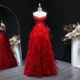 Full-length view of a floor-length ruffle skirt prom dress with appliqué detail