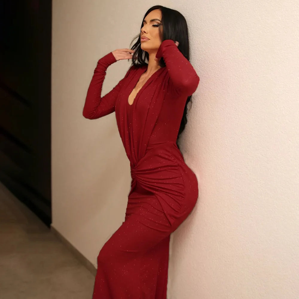 Front view of a red deep V maxi dress with clean lines and a fitted skirt, styled simply for an evening-ready silhouette.