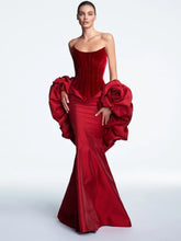 Red corset gown with detachable floral sleeves styled for formal events