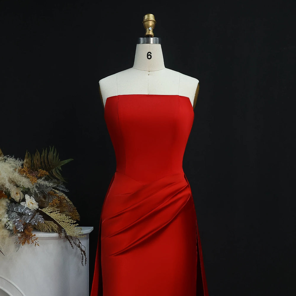 Strapless satin evening gown with sweep train in studio setting