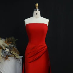 Strapless satin evening gown with sweep train in studio setting