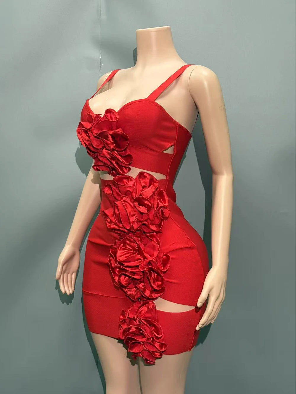 Red dress with floral details on a mannequin against a gray background