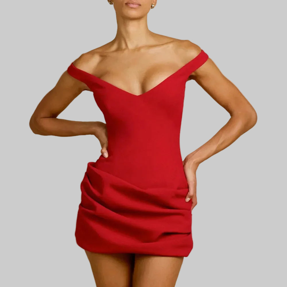 Close-up of the ruched skirt drape showing gathered folds that contour the waist and hips while keeping the silhouette smooth.