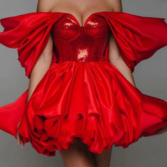 Close up of red sequin bodice and slash neckline on satin mini dress
